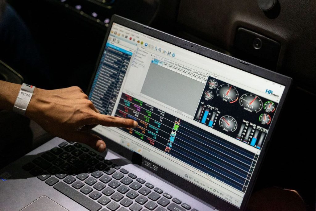 Finger pointing to a data log pulled inside VCM Scanner on a Laptop